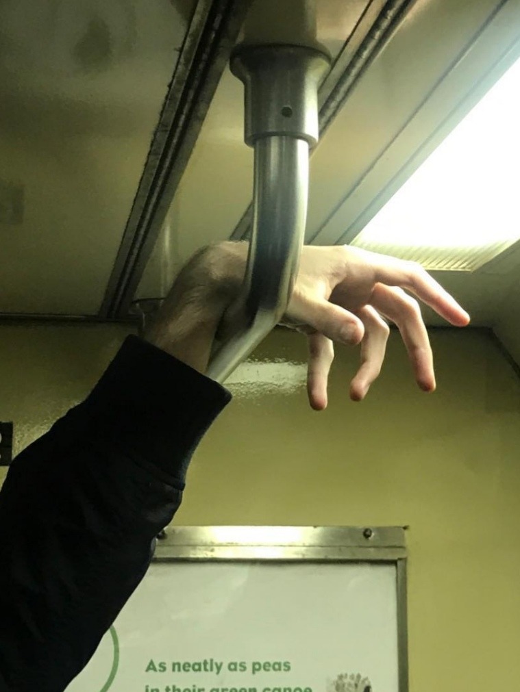 hand resting on a subway handle